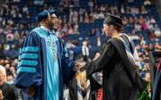 President Hemphill congratulates a student at the advanced degree commencement ceremony